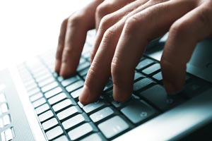 Hands Typing on a Laptop Hands Typing on a Laptop