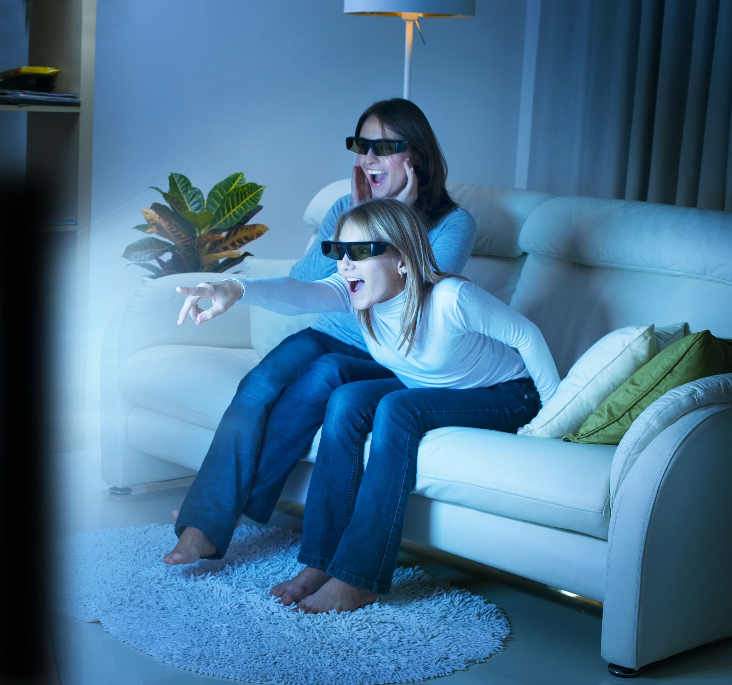 Mother and daughter watching 3D TV